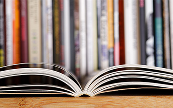 Book opened with books in the background