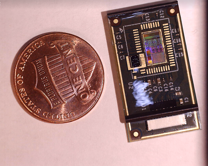 Tiny wearable sensor next to a penny